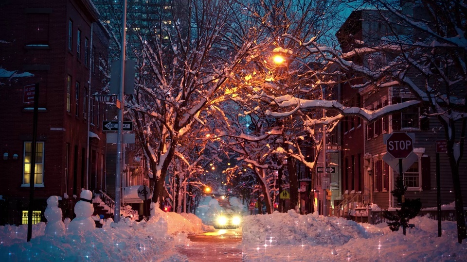 Warm snowy night street lights