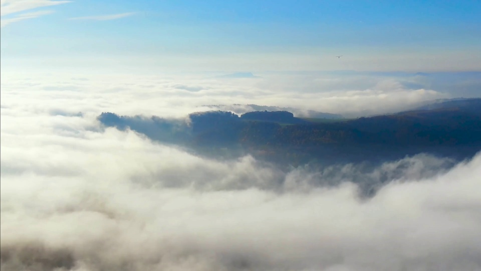 A glider flying through the clouds.